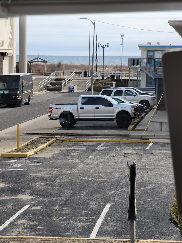 view of vehicle parking featuring a water view