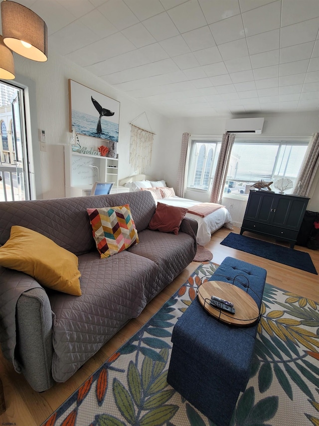 living room featuring a wall unit AC and hardwood / wood-style floors