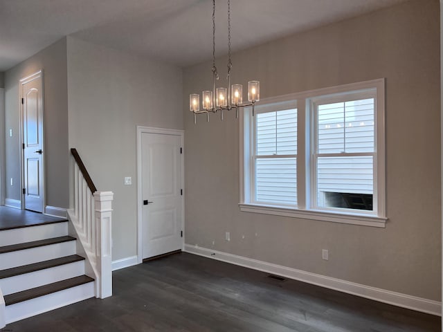 interior space featuring dark hardwood / wood-style flooring and a notable chandelier