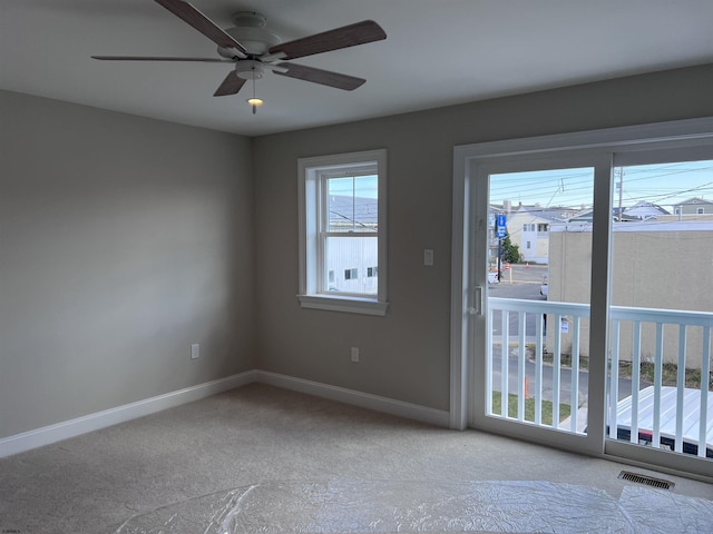 carpeted empty room featuring ceiling fan