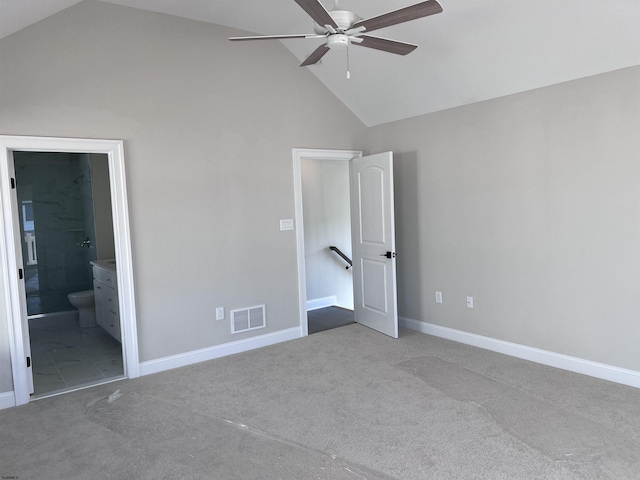 unfurnished bedroom featuring carpet flooring, high vaulted ceiling, ensuite bath, and ceiling fan