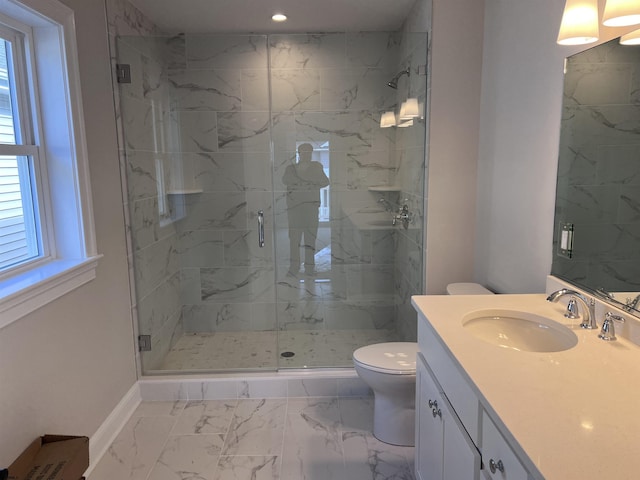 bathroom with toilet, vanity, and walk in shower