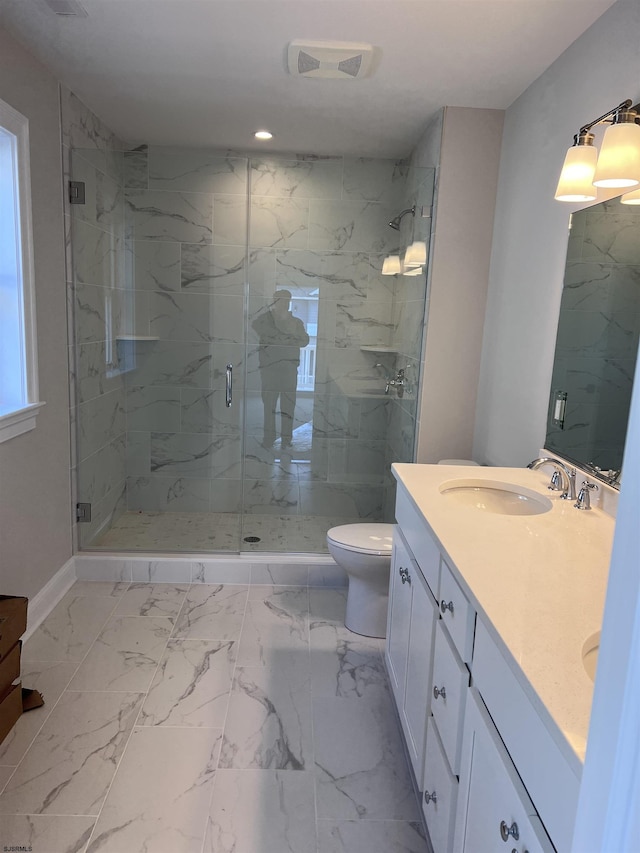 bathroom with a shower with door, vanity, and toilet