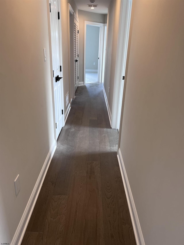 hallway with dark wood-type flooring