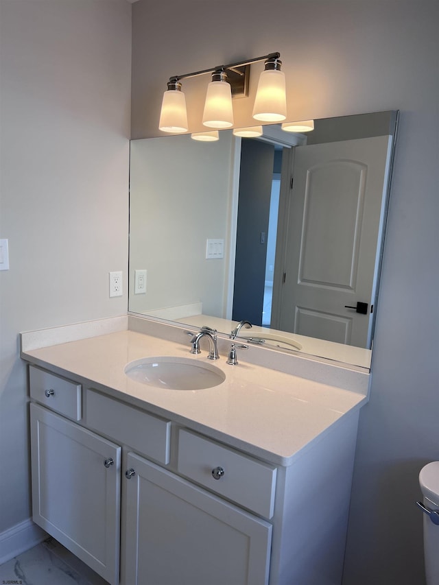 bathroom with vanity and toilet