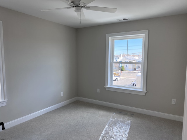 spare room featuring ceiling fan and light colored carpet