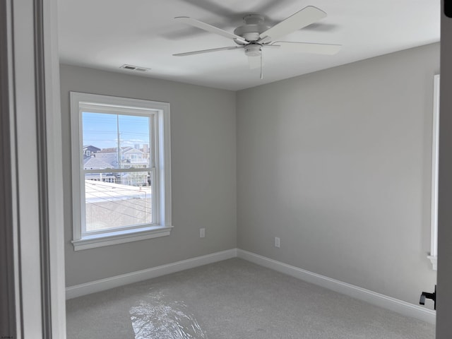 spare room featuring ceiling fan and a healthy amount of sunlight