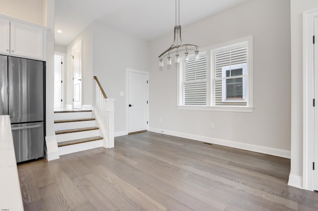 unfurnished dining area featuring hardwood / wood-style floors