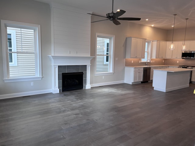 kitchen with white cabinetry, hanging light fixtures, a center island, and stainless steel appliances