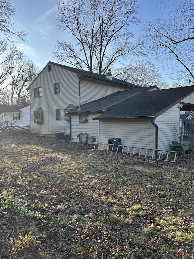 rear view of house featuring central air condition unit