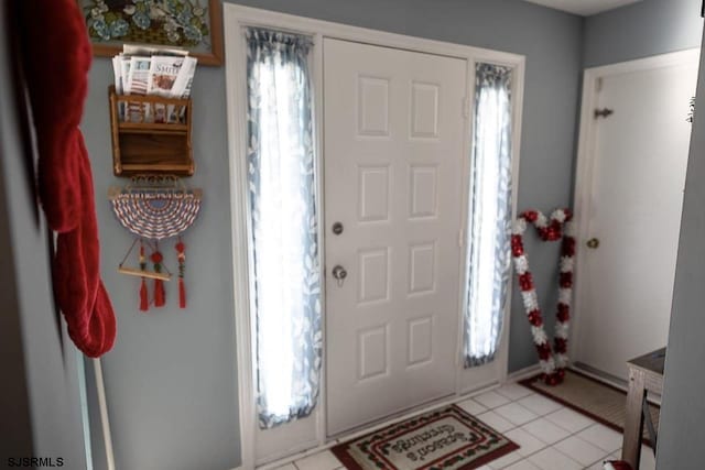 foyer entrance with light tile patterned flooring