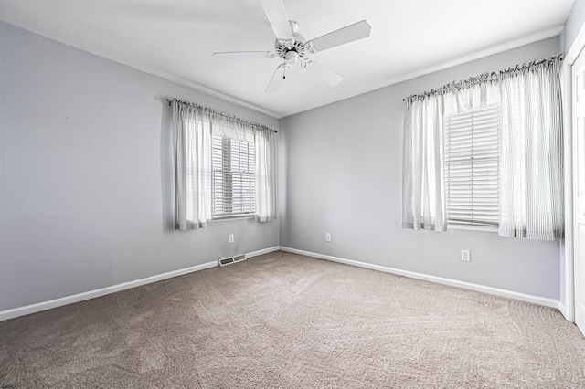 carpeted spare room with ceiling fan