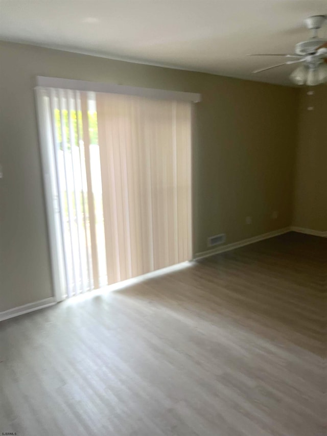 empty room featuring ceiling fan and hardwood / wood-style floors