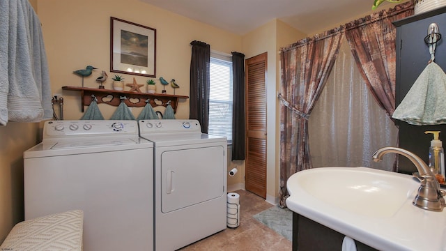 laundry area with washer and dryer, light tile patterned floors, and sink