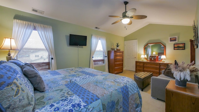 bedroom featuring ceiling fan, vaulted ceiling, light carpet, and multiple windows