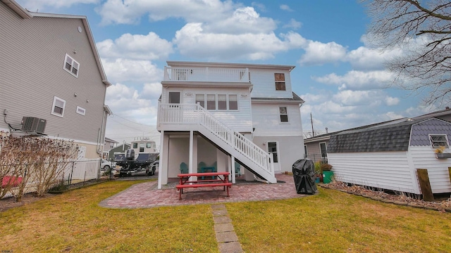 back of property featuring a patio area, central air condition unit, and a yard