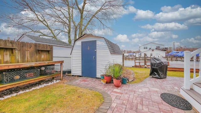 view of outdoor structure featuring a water view and a lawn