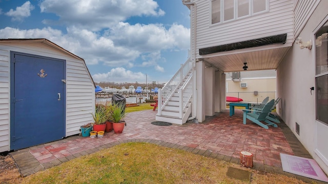 exterior space with a shed and a patio area