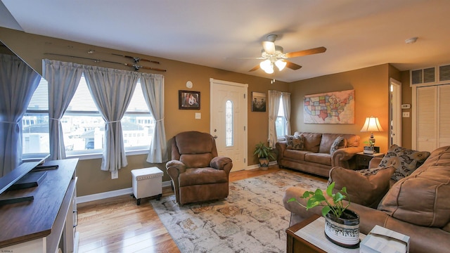 living room with ceiling fan and light hardwood / wood-style flooring