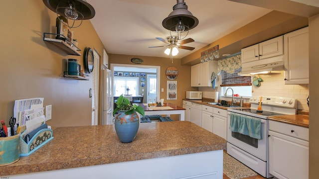 kitchen featuring tasteful backsplash, sink, white cabinets, and white appliances