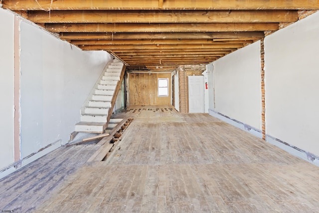 basement with hardwood / wood-style flooring