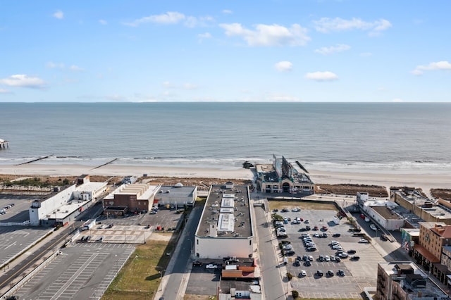 drone / aerial view featuring a view of the beach and a water view