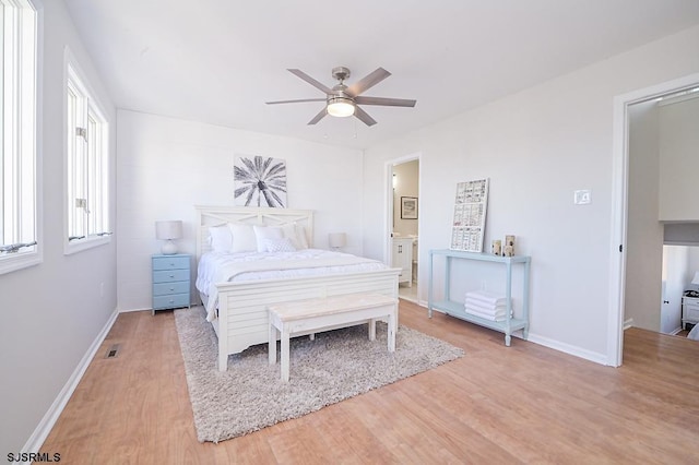 bedroom with light wood-type flooring, ensuite bath, and ceiling fan