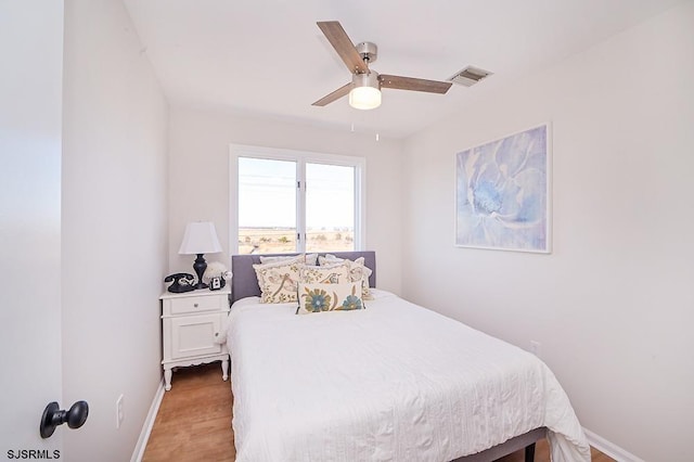 bedroom with ceiling fan and light hardwood / wood-style flooring