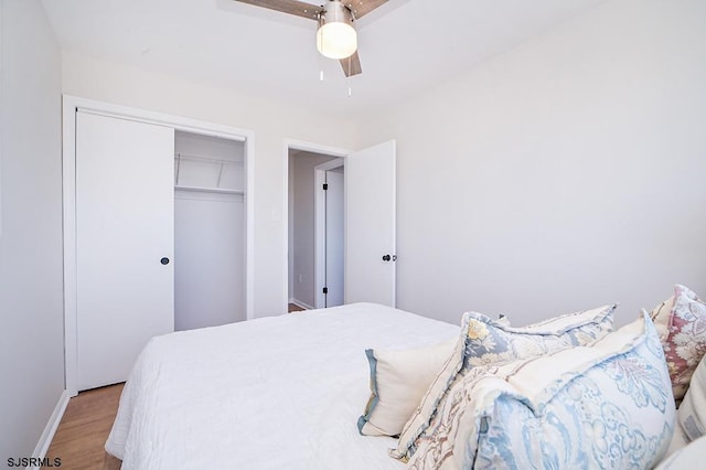 bedroom featuring ceiling fan, light hardwood / wood-style floors, and a closet