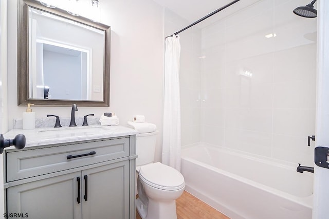 full bathroom with hardwood / wood-style flooring, vanity, toilet, and shower / bath combo with shower curtain