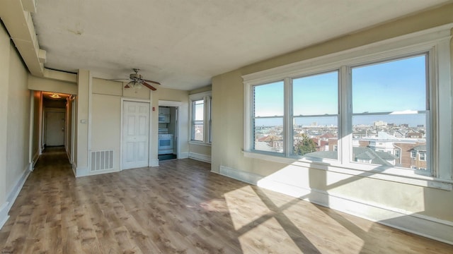 interior space with light hardwood / wood-style floors and ceiling fan