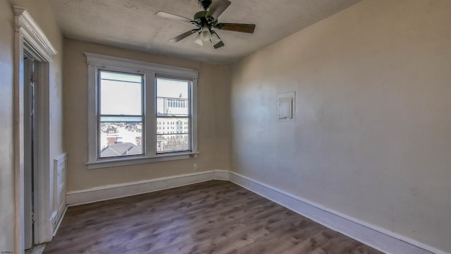 unfurnished room featuring ceiling fan and dark wood-type flooring