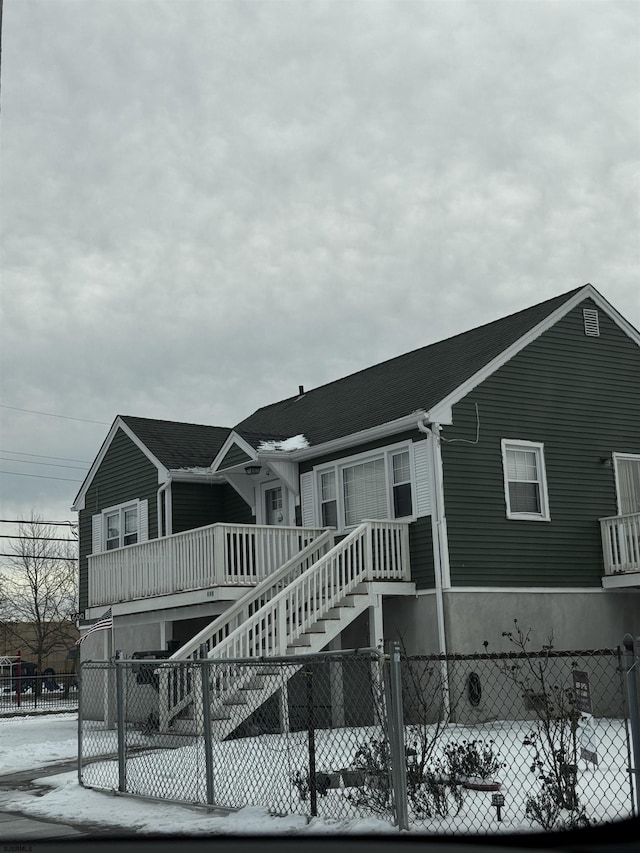 view of front of house featuring fence and stairs