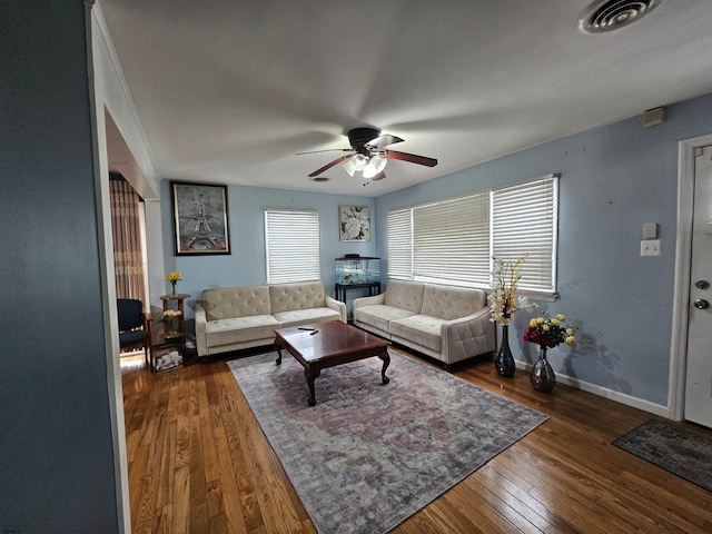 living area with ceiling fan, baseboards, visible vents, and dark wood finished floors