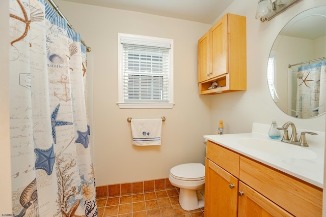 bathroom with tile patterned flooring, vanity, toilet, and a shower with curtain