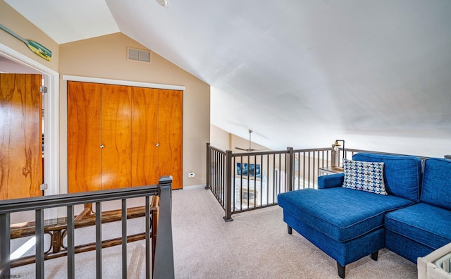 living area with light carpet and vaulted ceiling