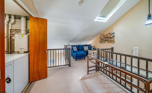 bedroom with lofted ceiling with skylight and independent washer and dryer