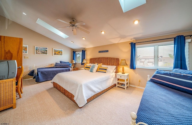 bedroom with carpet, ceiling fan, and vaulted ceiling with skylight