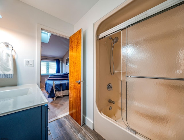 bathroom featuring vanity and bath / shower combo with glass door