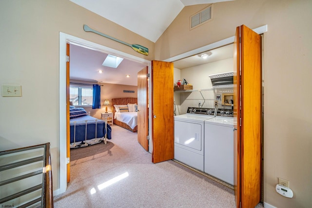 laundry area with separate washer and dryer and a skylight