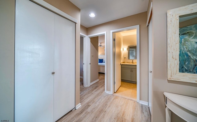 corridor featuring light hardwood / wood-style floors and sink