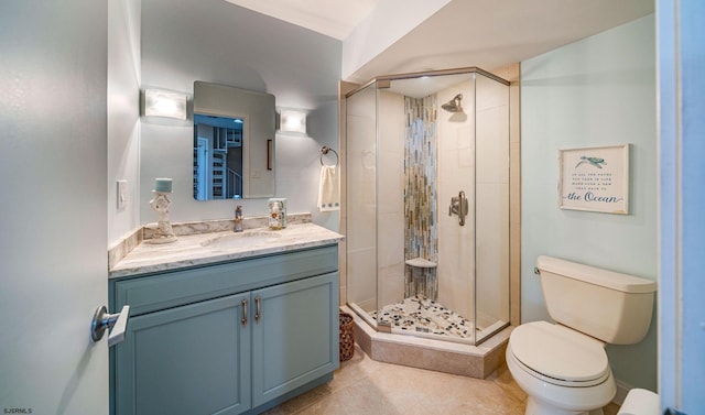 bathroom featuring tile patterned flooring, a shower with door, vanity, and toilet