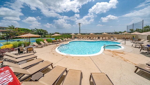 view of pool featuring a patio and tennis court