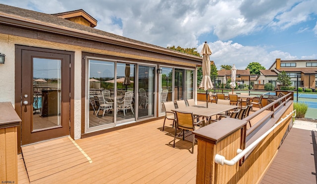 wooden terrace with tennis court