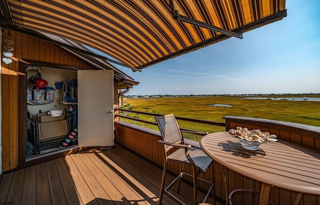 balcony featuring a rural view and a water view