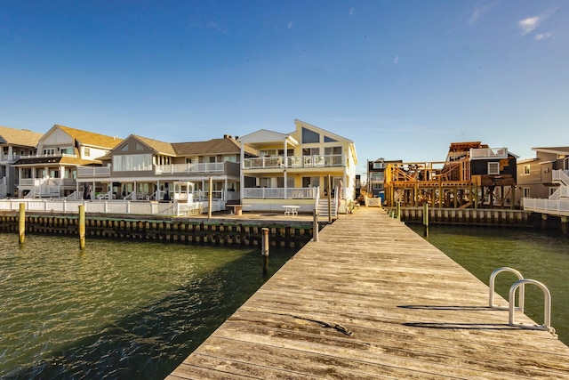 dock area featuring a residential view and a water view