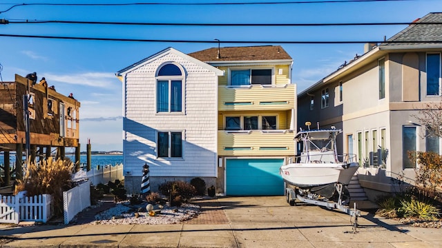 view of property featuring a garage and a water view