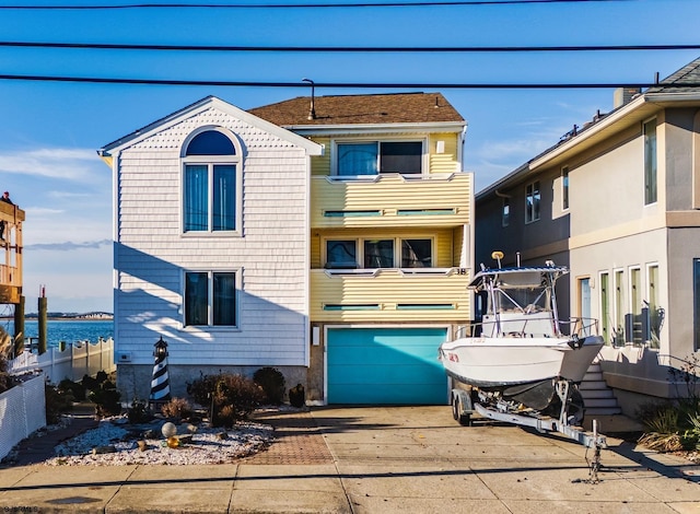 view of property with a garage and a water view