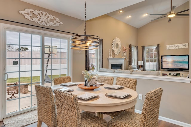 dining room featuring ceiling fan with notable chandelier and hardwood / wood-style flooring