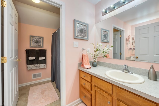 bathroom featuring tile patterned flooring and vanity